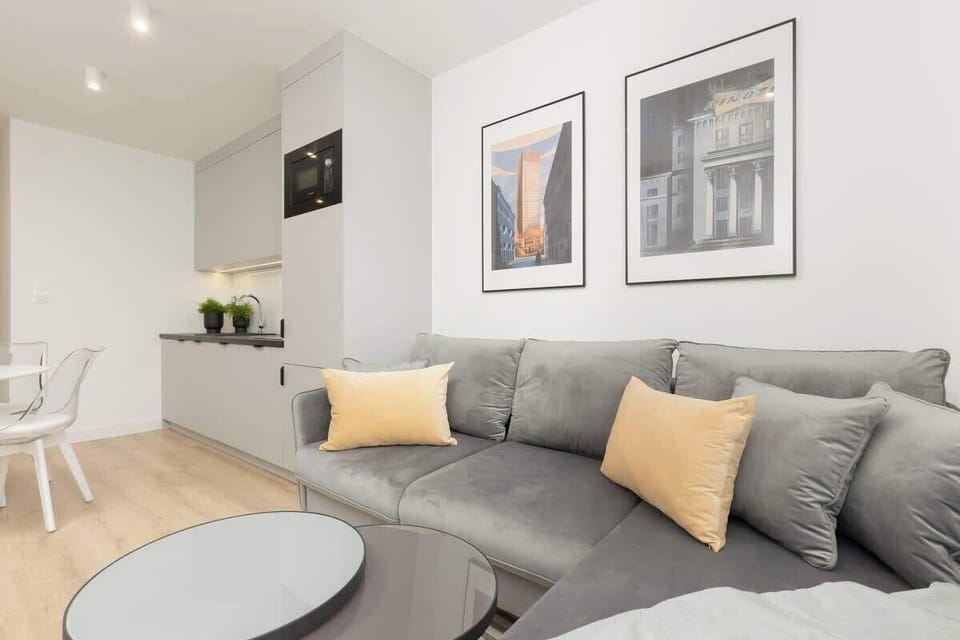 A different angle of the living room, highlighting the kitchen and dining area in an open-plan setting.
