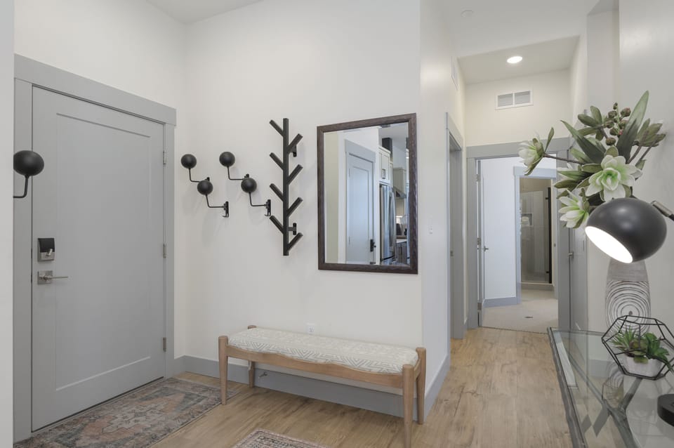 Step into your stylish entryway where modern design meets functionality. Hang your coat on the tree-style hooks and settle on the cushioned bench.
