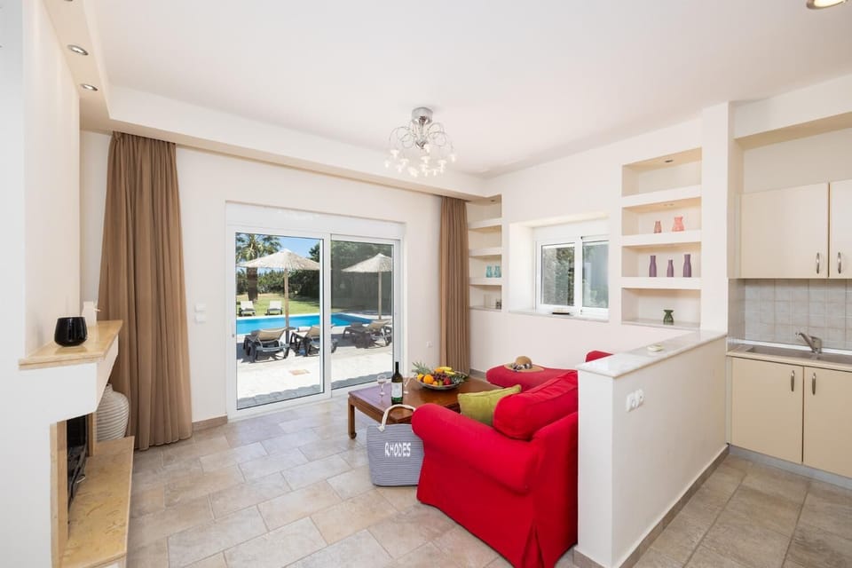 Annex: open-plan living room with sofa, kitchen, ornamental fireplace, A/C, and sea views