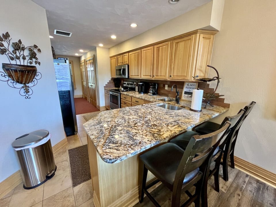 Fully equipped kitchen with granite countertops & stainless appliances