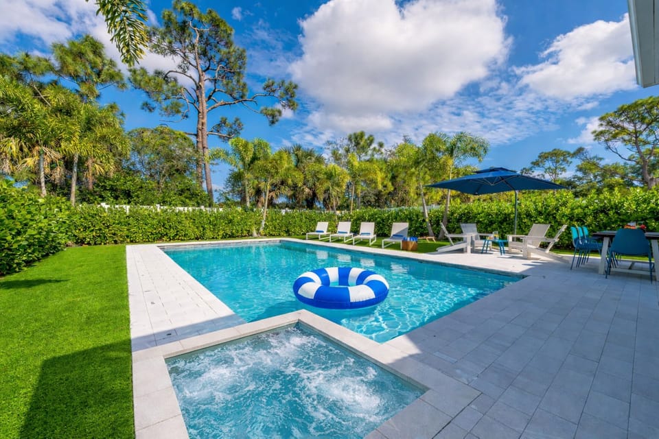 Welcome to our tropical outdoor paradise, where relaxation and outdoor enjoyment meet in perfect harmony. The centerpiece of this outdoor oasis is the large SALTWATER pool and hot tub, where you can cool off on hot days. BBQ and dine al-fresca!