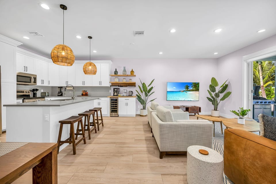 The open plan layout connects the kitchen seamlessly to the dining and living areas, allowing for easy flow and interaction with guests. It's perfect for hosting dinner parties, family gatherings, or simply enjoying the company of loved ones while prepari