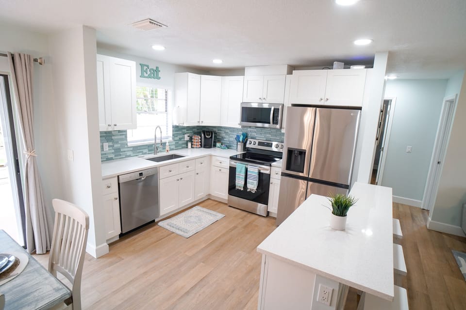 Fully-equipped kitchen w/stainless steel appliances and dishes/cooking supplies
