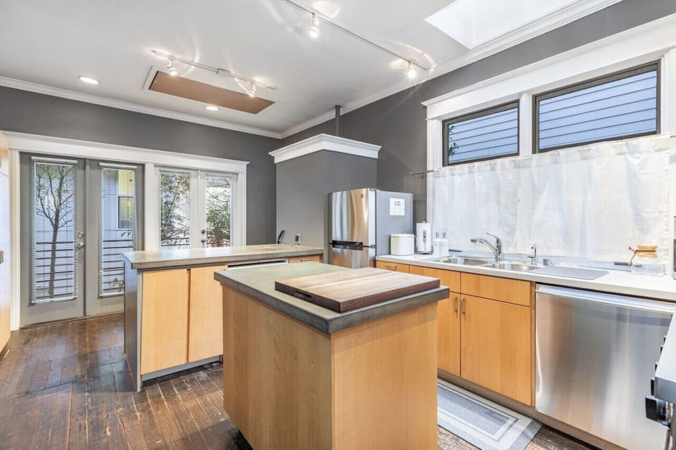 Well-lit kitchen with a cozy island and modern design.
