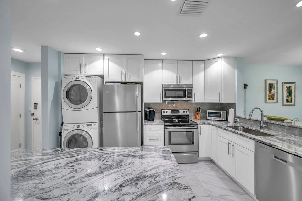 Kitchen View With In Unit Washer and Dryer