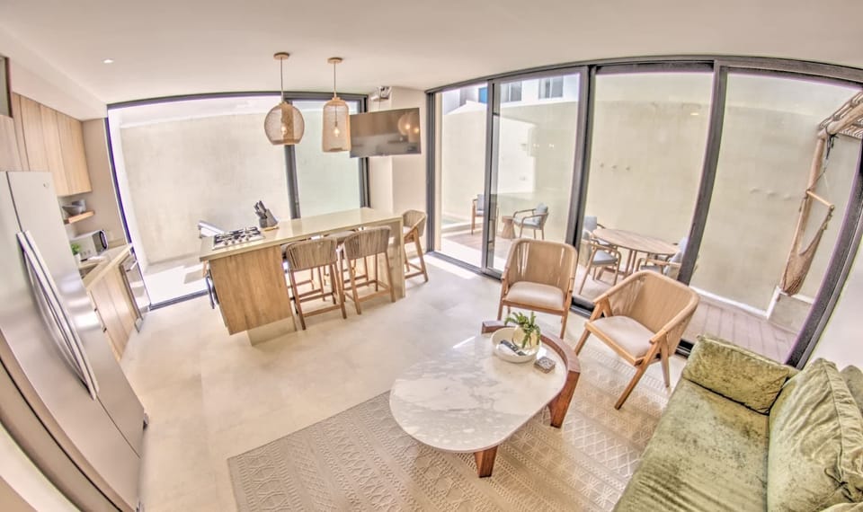 Living room & kitchen that opens up to private pool