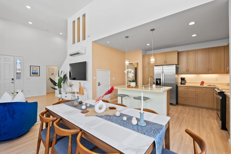 Dining table has seating for 8, with additional barstool seating in the kitchen.