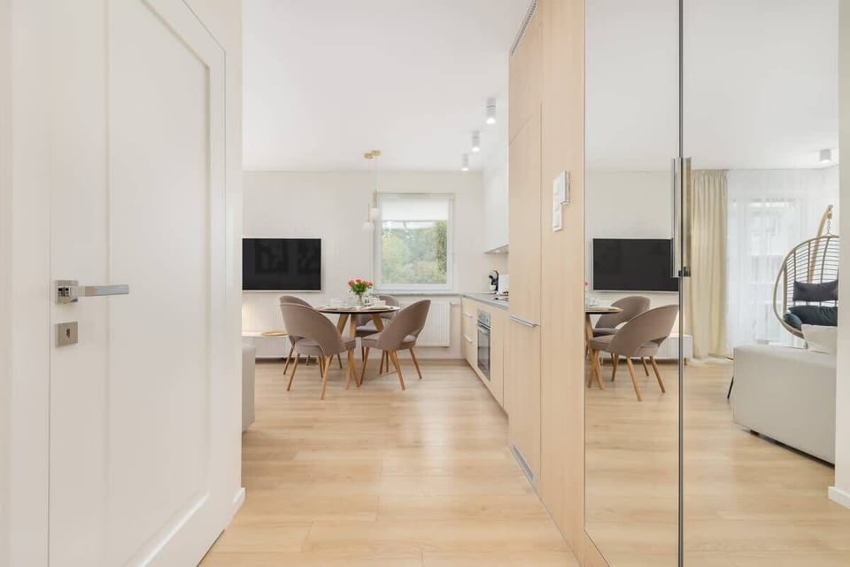 A different angle of the hallway, showcasing the open-plan design and bright interiors.
