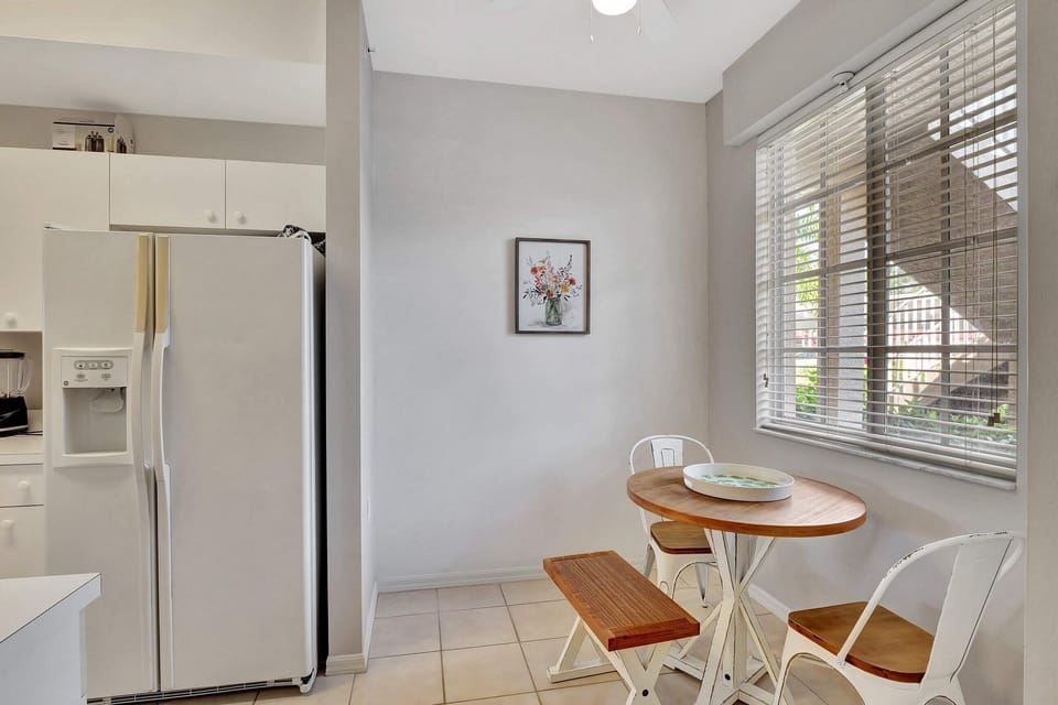 The kitchen has a small dining set that comfortably seats 2 people