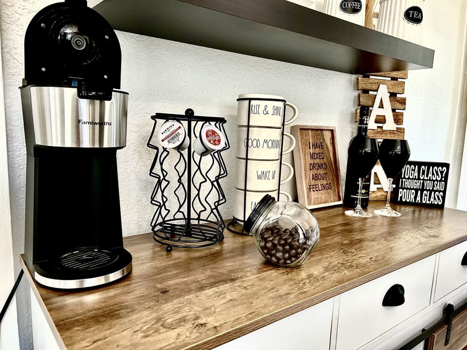 Coffee Bar. Hot or cold brew coffee maker. Utensils & kitchen supplies in bar.