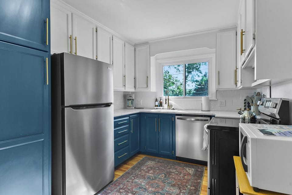 Your fully equipped kitchen features elegant two-tone cabinetry, stainless steel appliances, and everything you need to cook memorable meals during your stay.