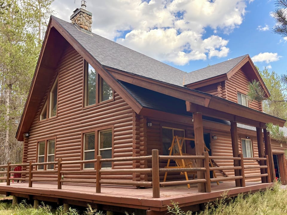 This rustic two story cabin with wraparound deck is your home away from home!