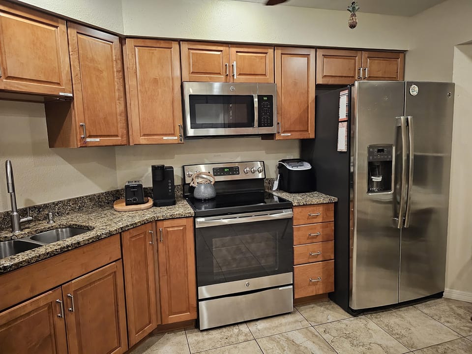 dishwasher,  microwave,  oven and range,  fully stocked kitchenware