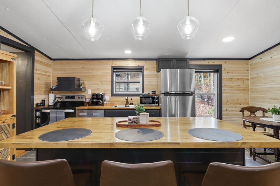 Full kitchen with island seating and stainless steel appliances