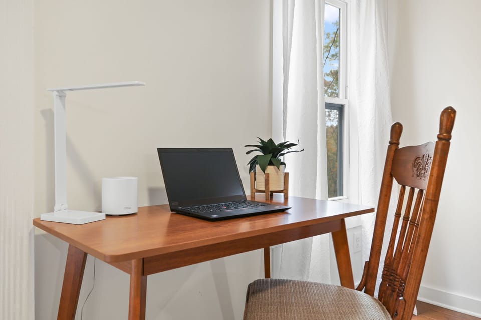 Bedroom workspace with desk and natural light for remote work