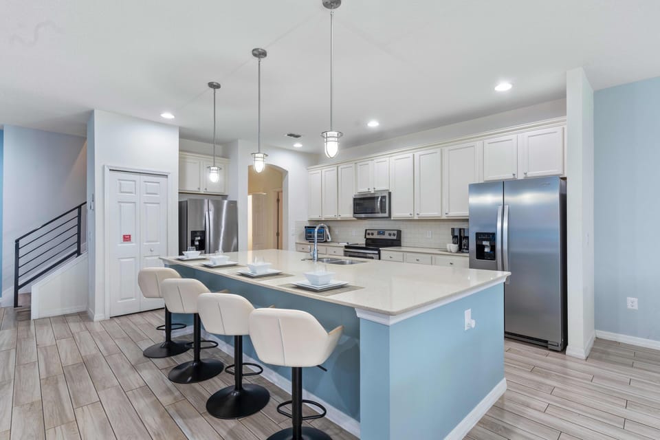 - Modern kitchen with stainless appliances and island seating  
- Open plan layout ideal for cooking dining and group stays  
- Fully equipped space designed for family and friends
