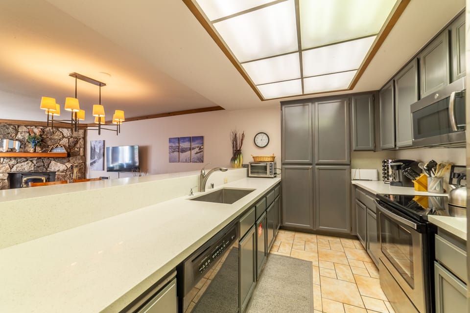 Kitchen with refinished cabinets and solid countertops.
