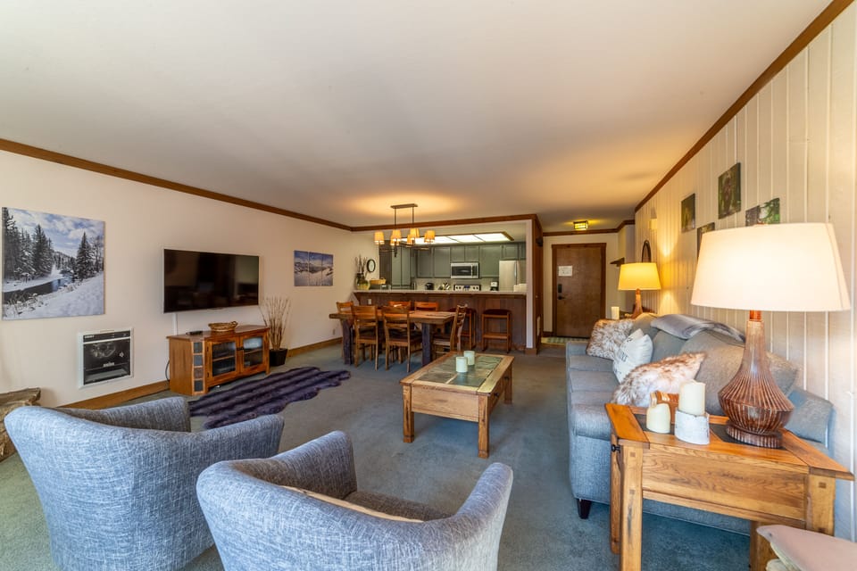Open living room with large flatscreen TV.