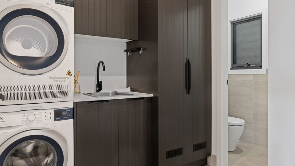 Laundry with drying cupboard and toilet