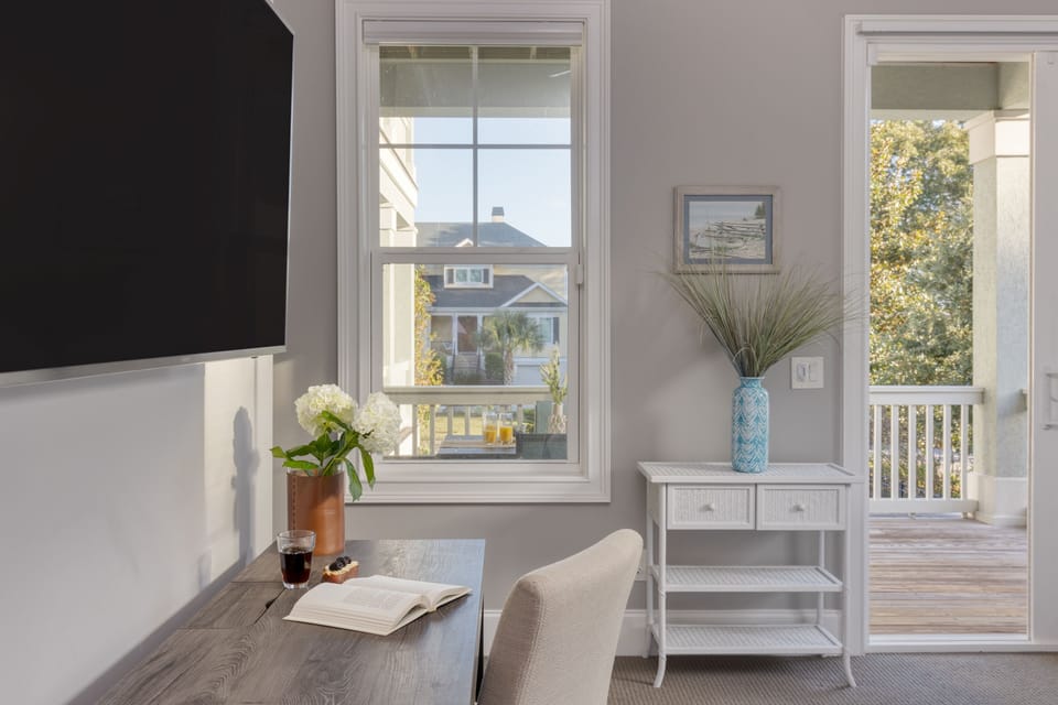 Desk, TV, and deck access in the primary bedroom.