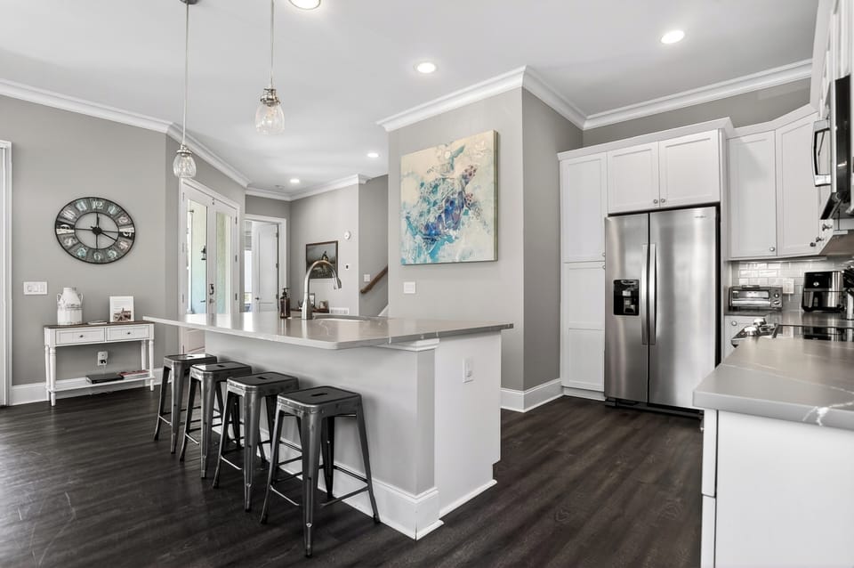 Fully equipped kitchen with barstool seating and a full suite of appliances.