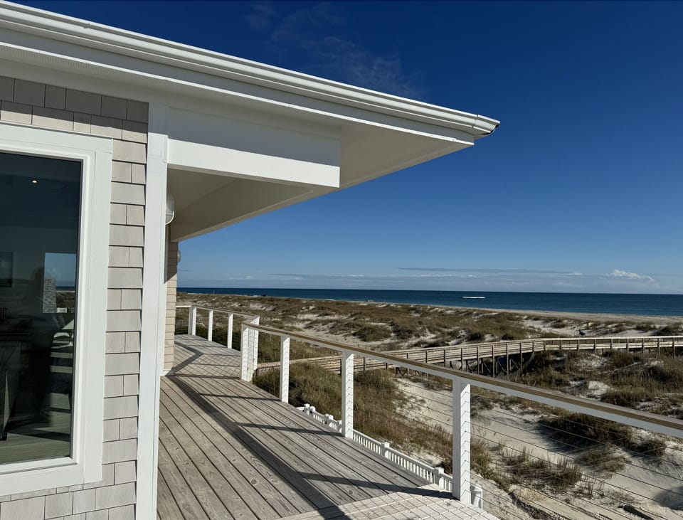 Third story wrap around deck is choice for dining al fresco. 