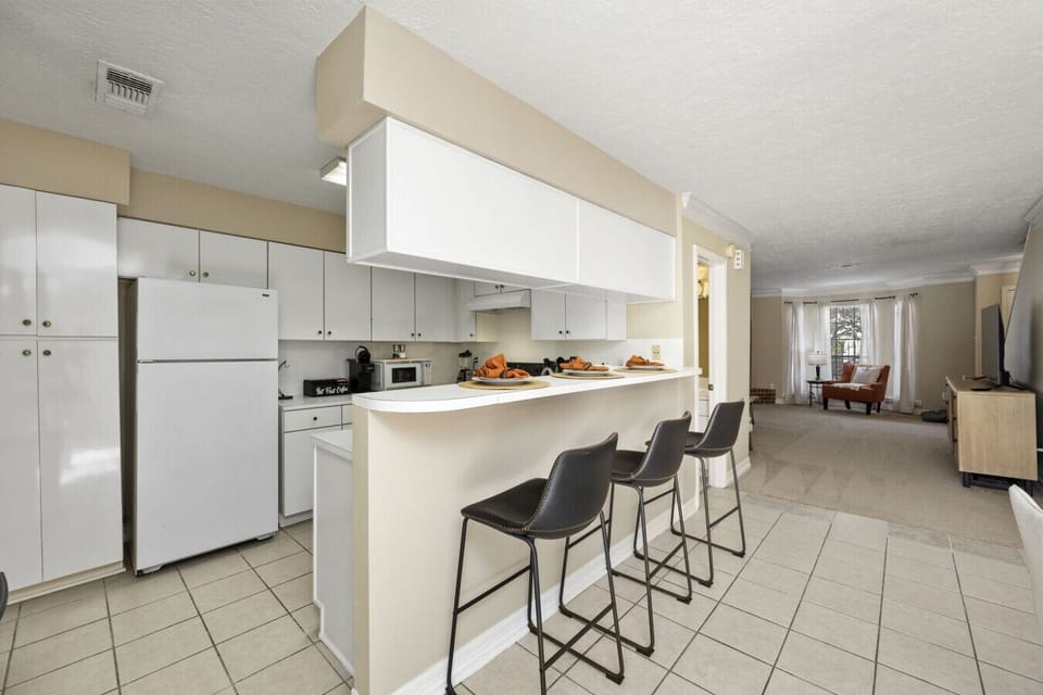 Fully equipped kitchen with breakfast bar seating and everything needed to prepare meals