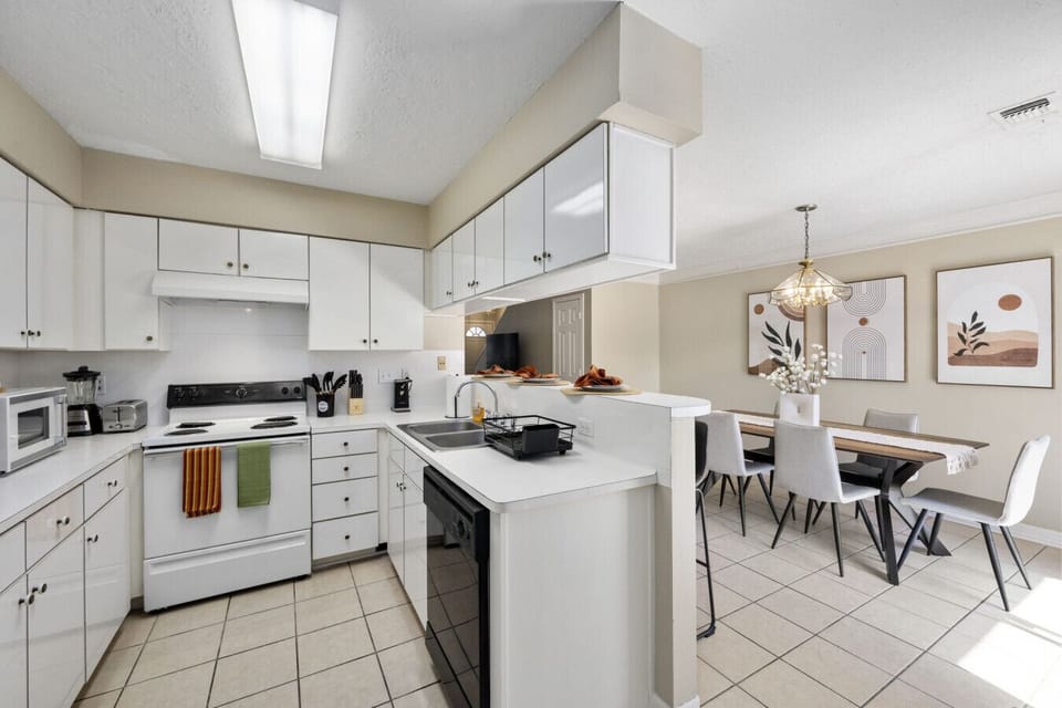 Bright open kitchen with dining table for 6 and island seating for 3
