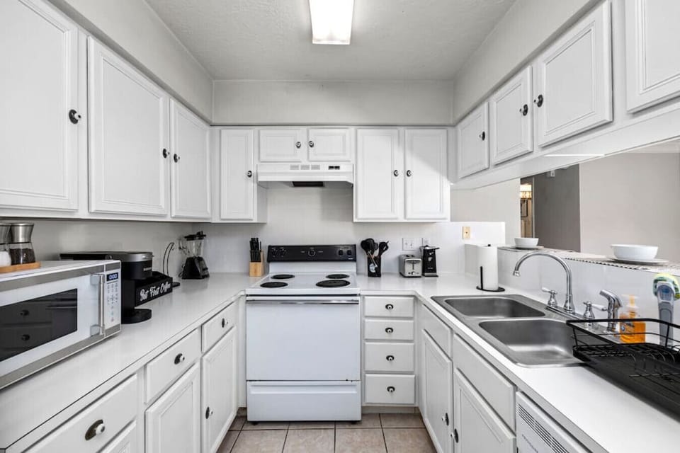 Fully stocked kitchen with stove, oven, microwave, dishwasher, and everything needed to cook at home