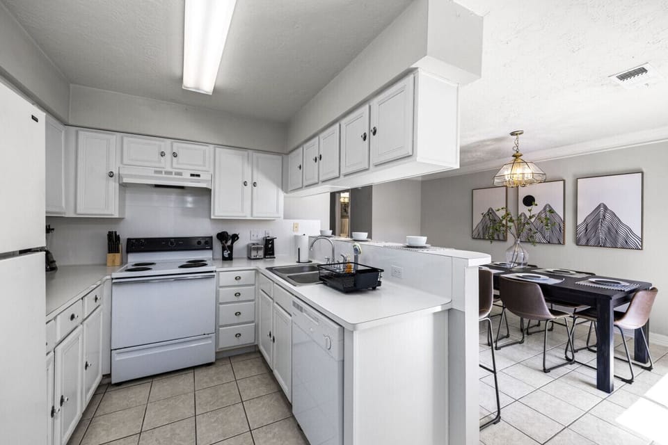 Bright kitchen with pass-through bar and adjacent dining area