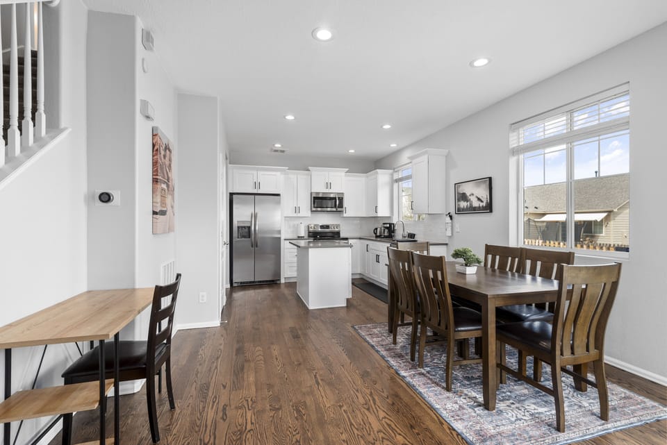 Dining room and kitchen connecting from the living room with an open floor plan