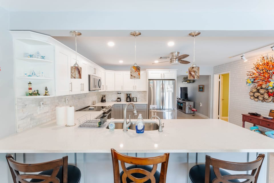Craft culinary masterpieces in our gourmet kitchen with spacious bar seating.