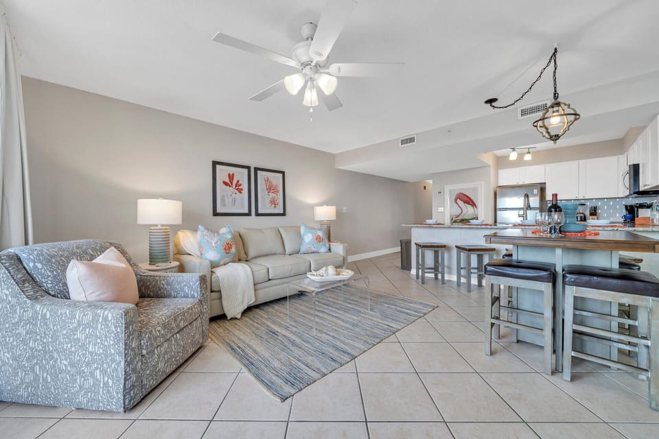 Relax in your bright, open-concept living space where coastal colors and comfortable seating create the perfect atmosphere for vacation downtime.