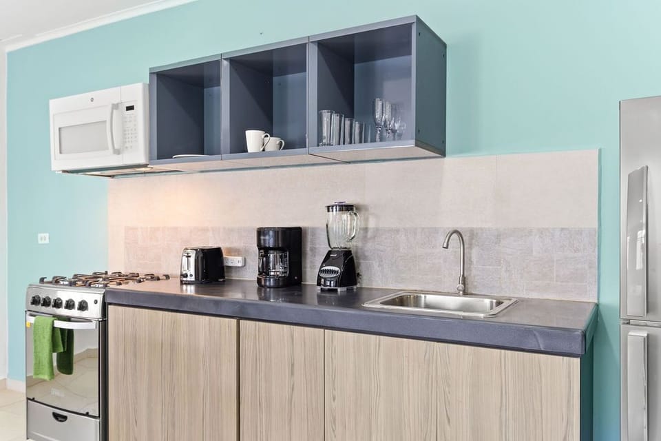 Whether you're craving a quick bite or planning a gourmet feast, our studio unit's small kitchenette has everything you need to satisfy your culinary desires.