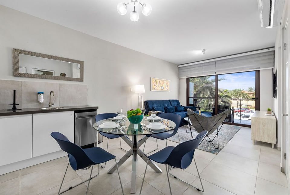 Open-plan kitchen and living area with chic furnishings and a stunning view.