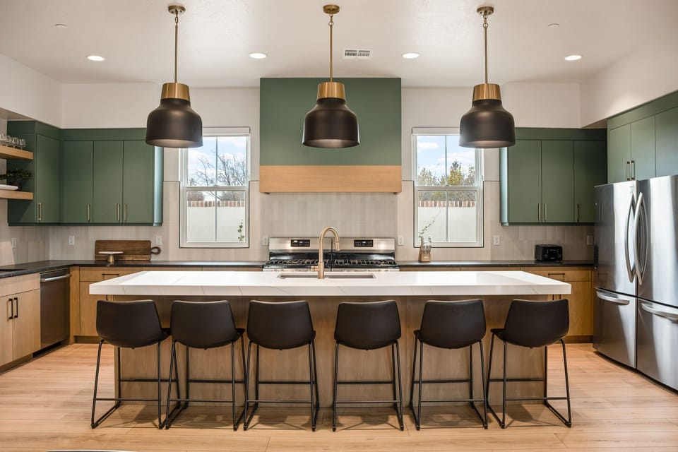 Two stoves, sinks, and fridges