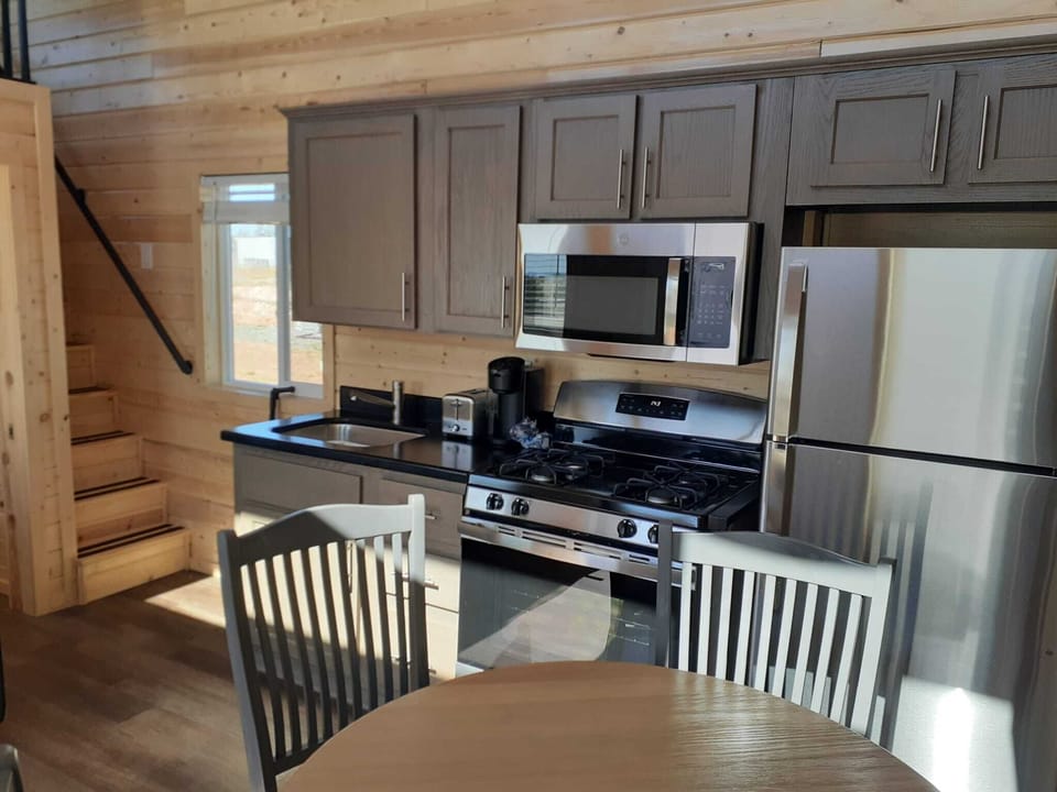 Full Kitchen: Microwave, Refrigerator, Kitchen Stove, Family dining table. 