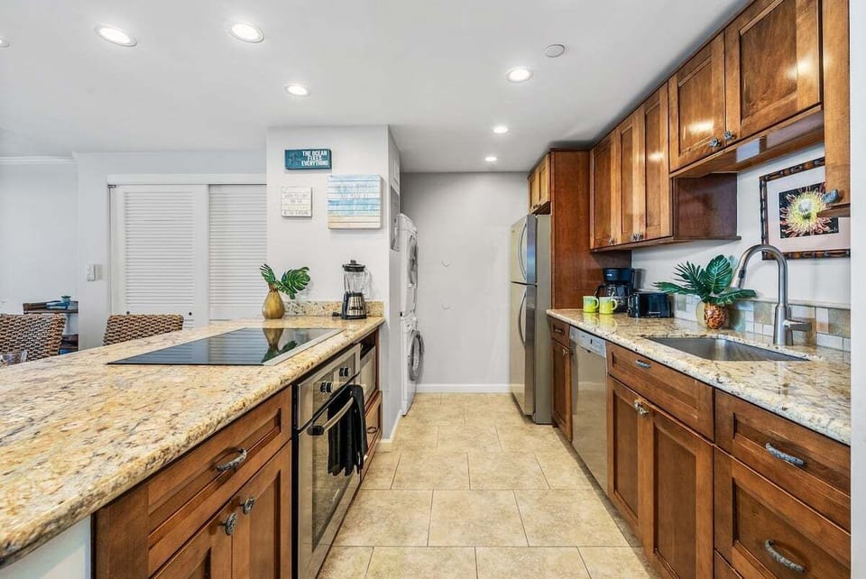 Modern kitchen with granite counters and stainless shine — cook up something tasty, then head straight for the waves.