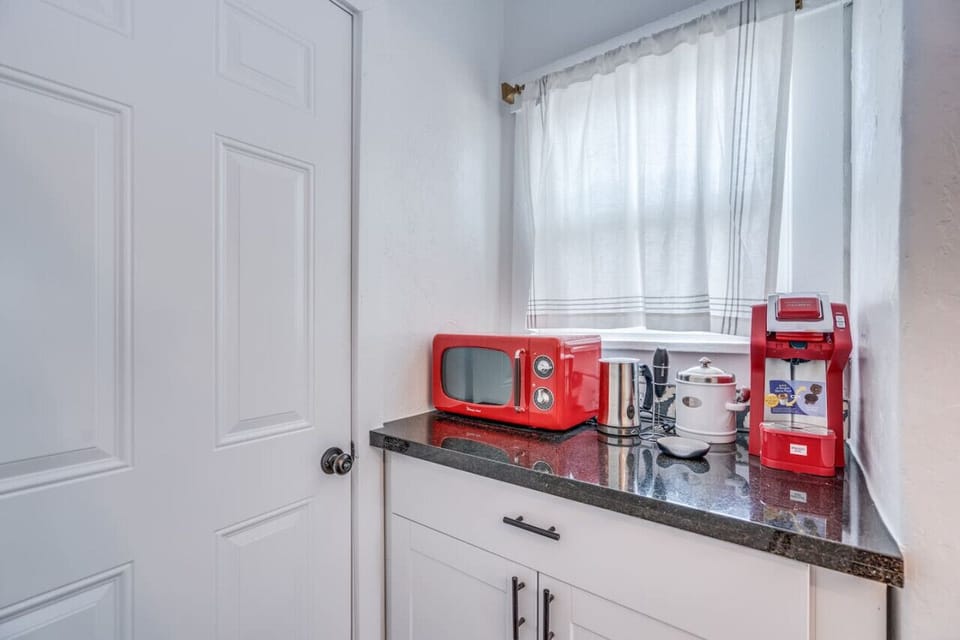 Coffee bar complete with coffee, milk frother, and retro microwave