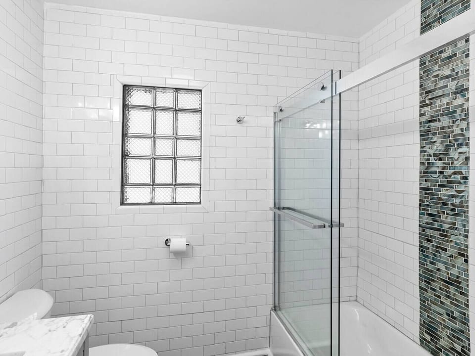 Hallway Bathroom With Tub and Shower