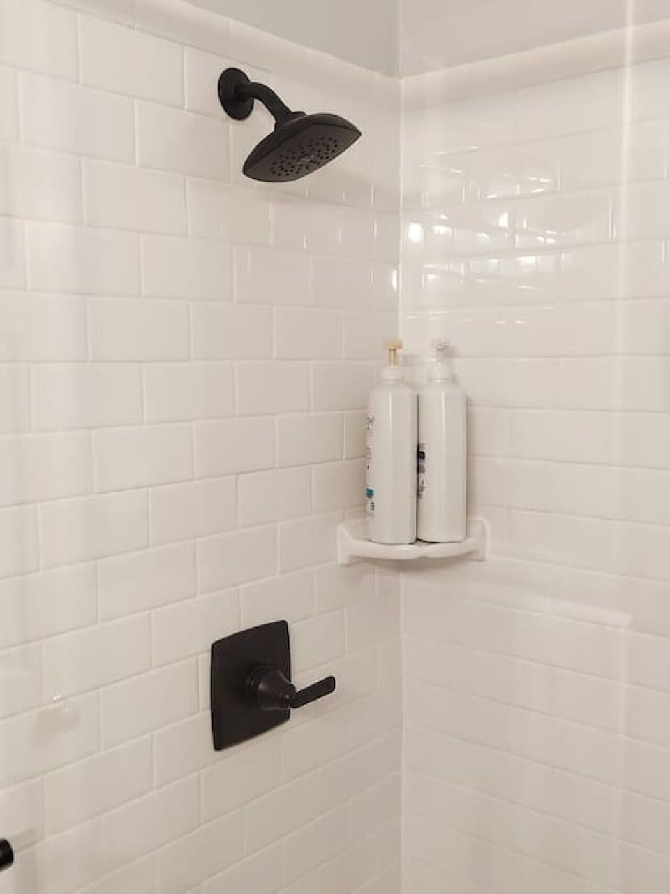Shower with shampoo, conditioner and body wash provided.