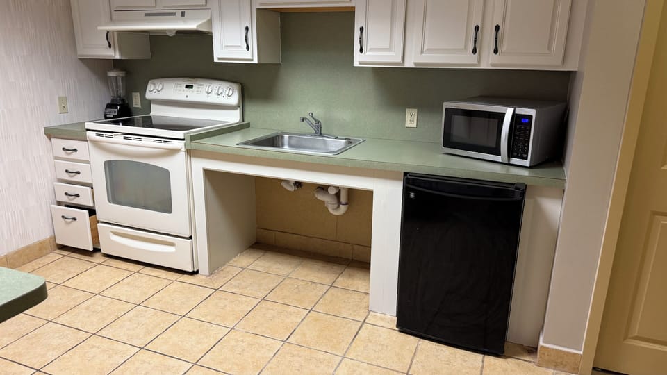 Suite, 1 King Bed, Hearing Accessible, Non Smoking | Private kitchen | Fridge, microwave, oven, stovetop