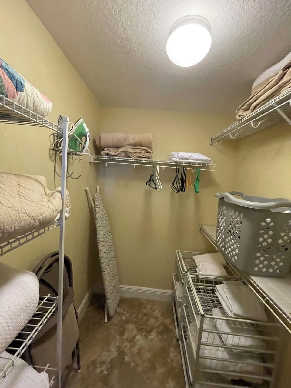 Large walk in closet with extra pillows, blankets, sheets, towels