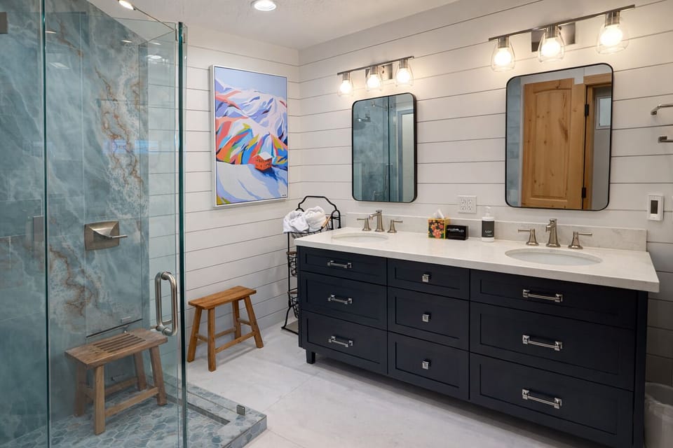 Beautifully updated bathroom with dual sinks, premium finishes, and a spacious walk-in shower.