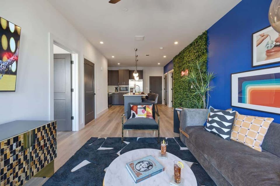 Bright open living space featuring a smart flat-screen TV and designer furnishings.