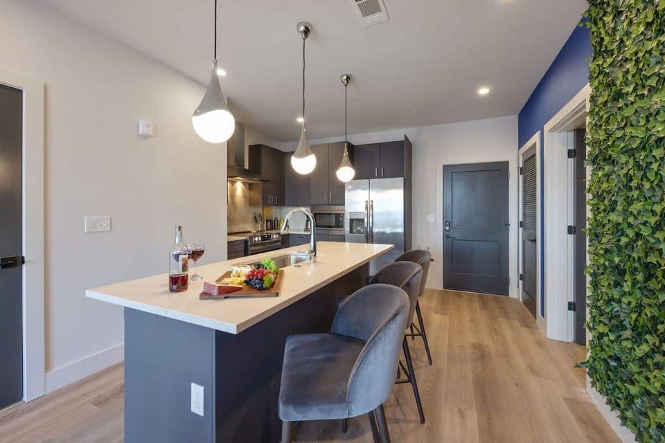 Fully equipped kitchen stocked with your basic cooking essentials, stainless steel appliances, and breakfast bar seating.