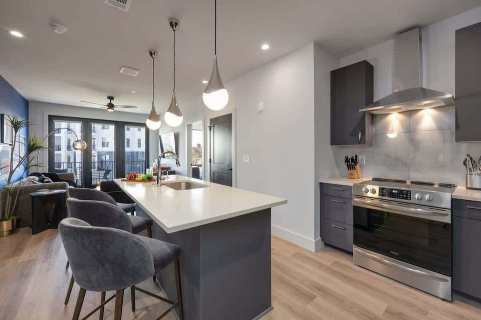 Fully equipped kitchen stocked with your basic cooking essentials, stainless steel appliances, and breakfast bar seating.