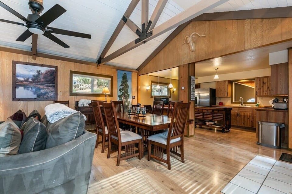 On the main floor of the home, a charming and open space greets you with lovely exposed wood beams and large windows filling the space with natural light.