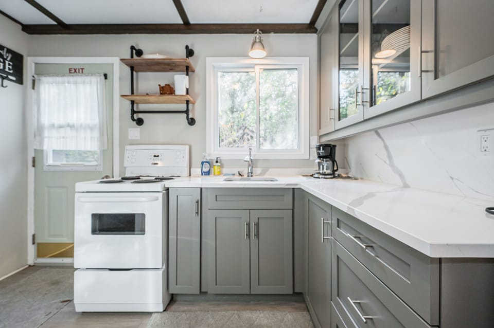 The kitchen is roomy and stocked with plenty of cookware and utensils for your use.
