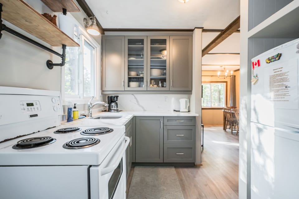 Modern appliances make cooking easy, with coffeemaker and kettle.